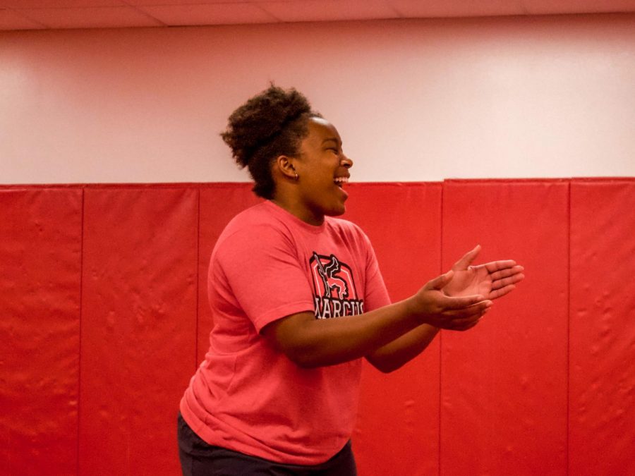 Coach Brittany Marshall claps enthusiastically for her wrestlers during practice. 