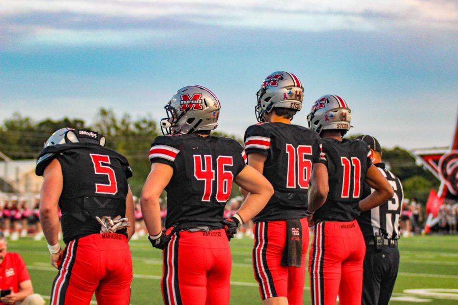 Dallas Dudley, wearing #11, stands with his teammates during the October Coppell game, which the Marauders won 39-37.