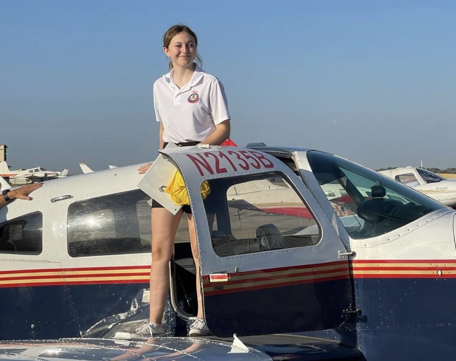 Senior Emily Kaslik climbs out of the Piper Cherokee after a successful solo flight.