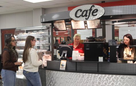 Students purchase coffee from cafeteria managers Kelly Gray and Jesse Rains at the main campus coffee stand.

Photo Jayni Gogineni