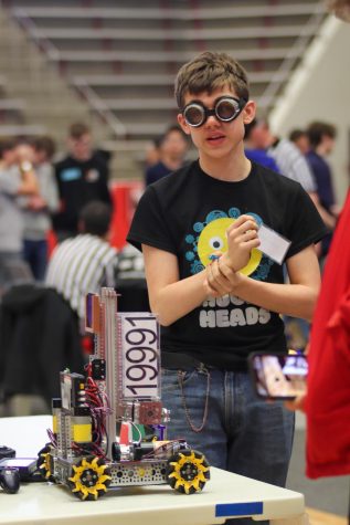Sophomore Finnian Shannahan prepares robot 19991 for the next round of the regional competition. Photo Bianca Mahendran