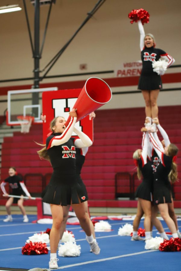 Varsity cheerleader Hallie Brown energizes the crowd during the teams routine show off before nationals. 