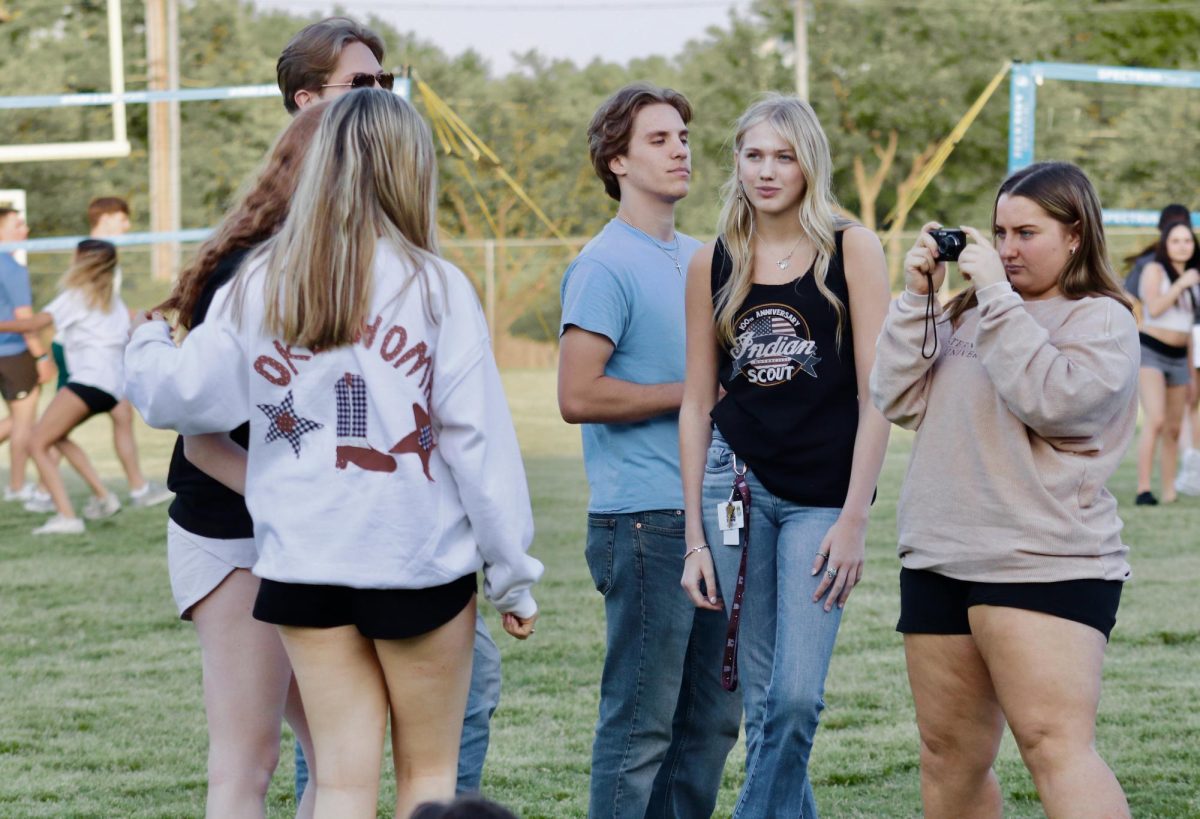 Hannah Geddes takes snapshots of fellow future graduates at Senior Sunset on April 17, 2025.
