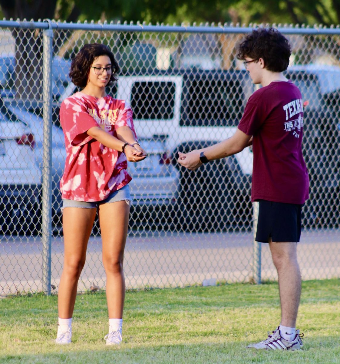 Christina Roquebert and Luke Rottman use part of their Senior Sunset time on April 17 to work on their volleyball return technique.
