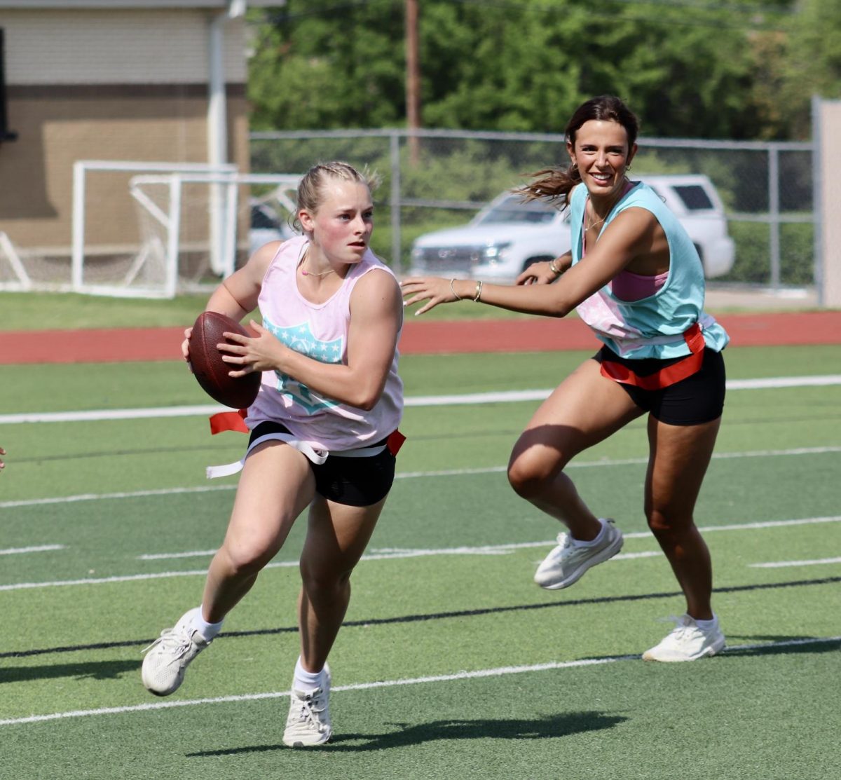 Lillie Robbirds, 11, turns upfield to avoid Jayden Suarez, 12, during the Senior's victory in the annual Powder Puff football game on April 17, 2025.