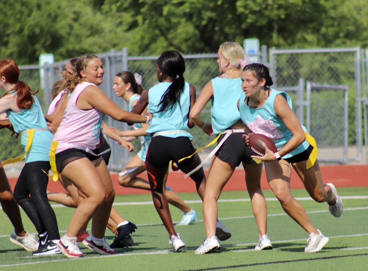 Isabelle Moreno, 12, spies a hole in the juniors' defense during the annual Powder Puff football game on April 17, 2025.