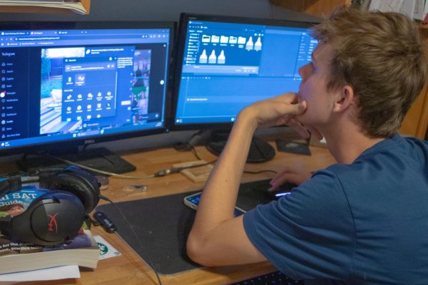 Kevin Reed edits video footage on his home computer set-up. Reed spends hours during this process before publishing his content online.